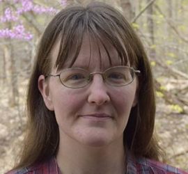 Head shot of Margaret with redbud in background