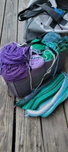 insert of yarn tote with yarn inside sitting in front of the tote itself