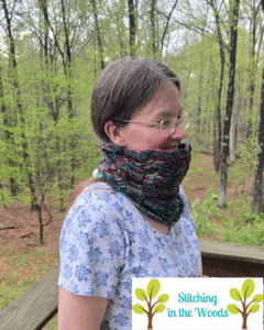 Margaret standing outside wearing a Shazam cowl she knitted (in addition to her other clothes of course)